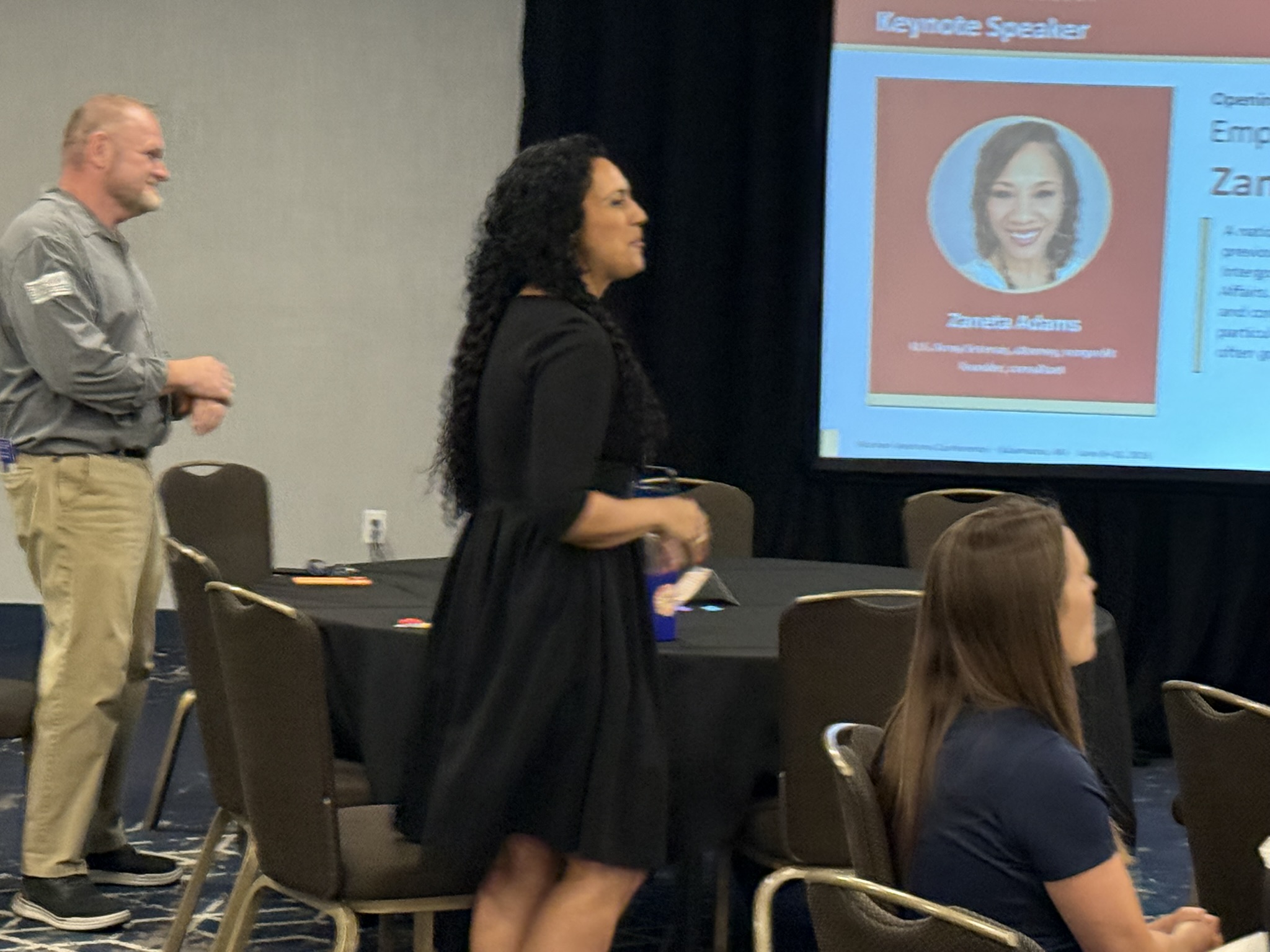 Women Veterans Conference 2026 — Speaker walking keynote slide