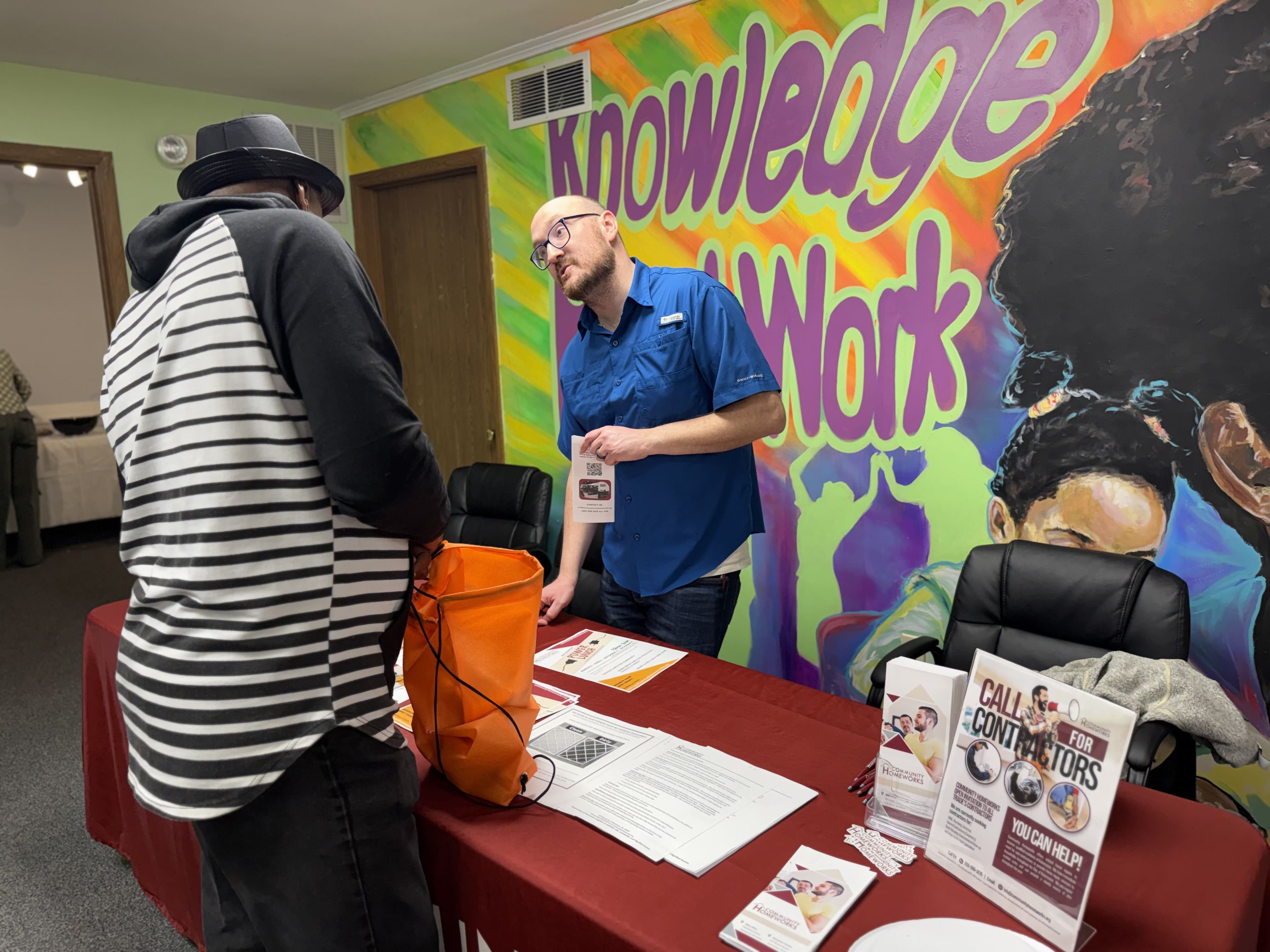 Volunteer helping at booth