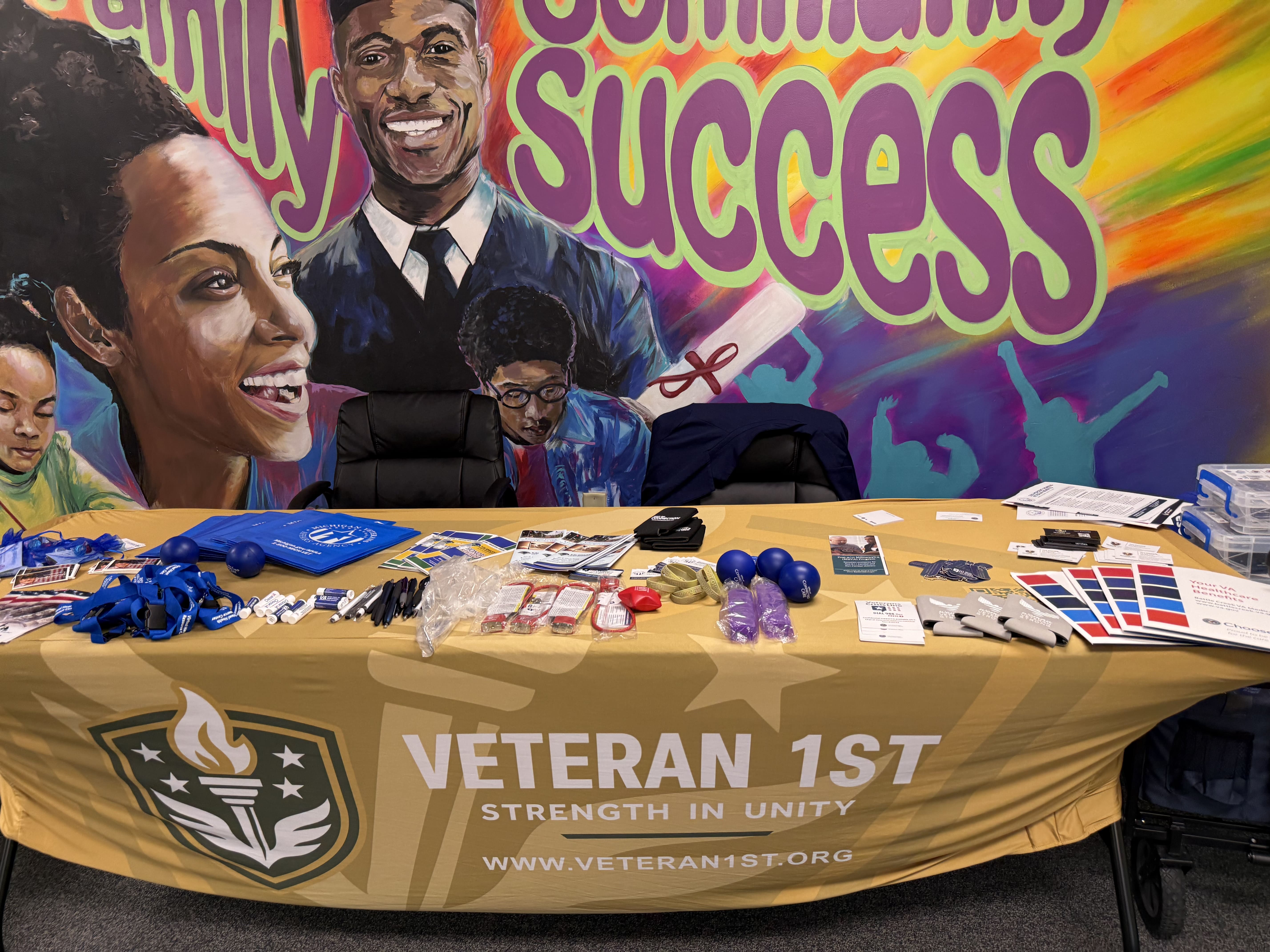 Veterans 1st booth with mural